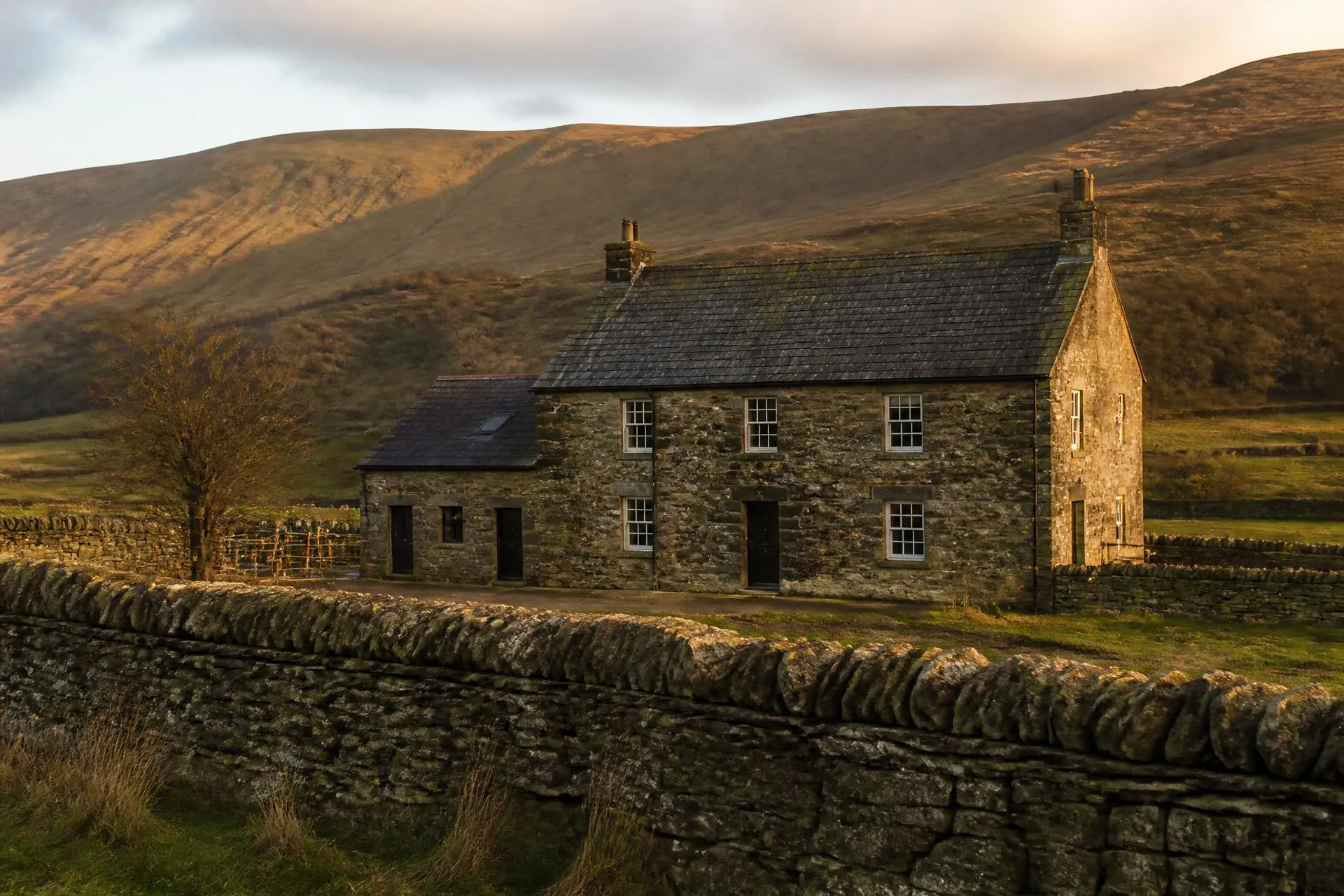 Stone farmhouse at dusk used as the Brecon & Dean Surveyors homepage image